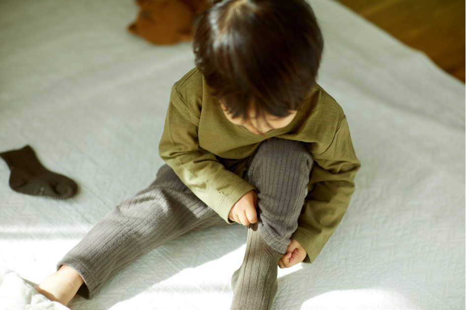 Niño pequeño poniendose calcetines